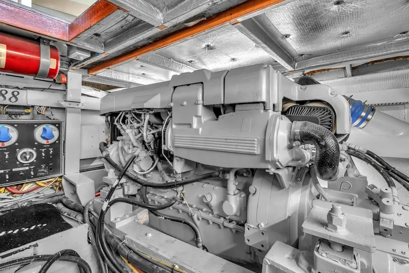 Slide: The Image of Engine room of a 1978 Hatteras 42 Convertible yacht, showcasing machinery and controls. - 41
