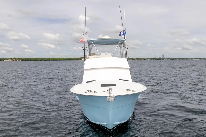 Slide: The Image of 1978 Hatteras 42 Convertible boat on open water, front view with clear sky. - 5