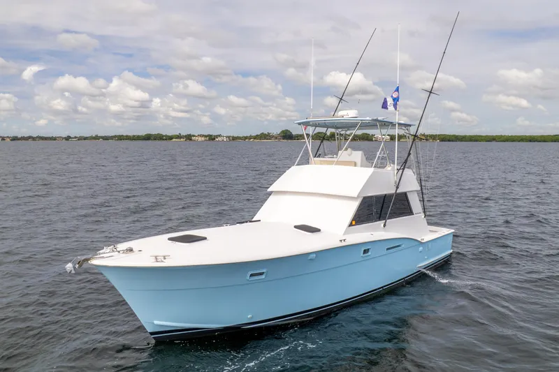 Slide: The Image of 1978 Hatteras 42 Convertible yacht on open water under a cloudy sky. - 8