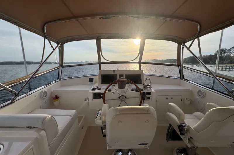 Slide: The Image of 2011 Grand Banks 47 Heritage EU yacht helm with sunset view over the water. - 28