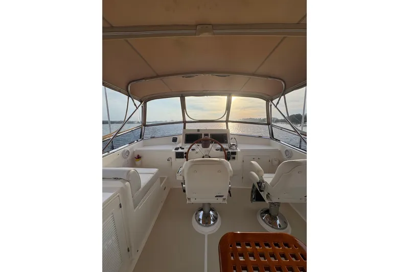 Slide: The Image of Flybridge of 2011 Grand Banks 47 Heritage EU yacht at sunset, featuring helm and seating. - 33