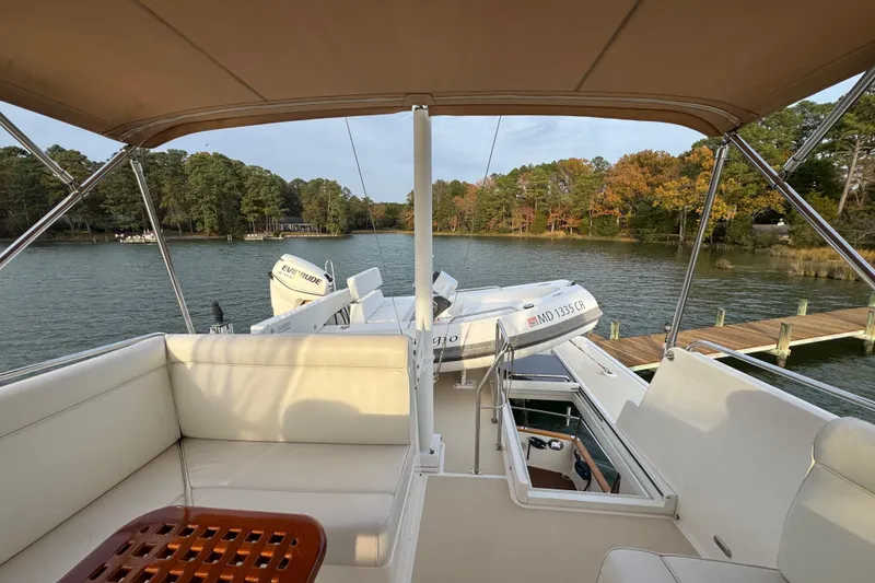 Slide: The Image of 2011 Grand Banks 47 Heritage EU yacht on serene lake with lush forest backdrop. - 36