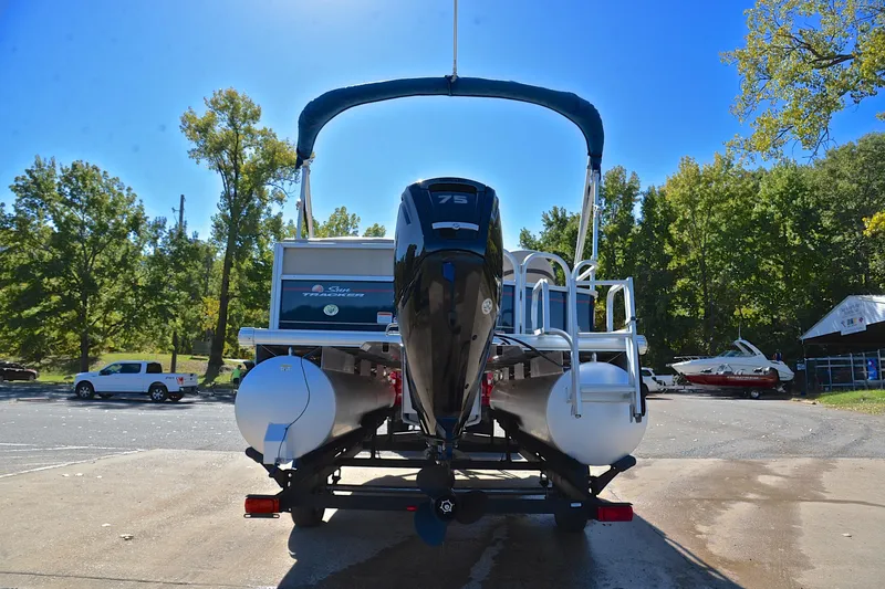 Slide: The Image of 2019 Sun Tracker Party Barge 18 DLX pontoon boat on trailer, parked outdoors. - 13
