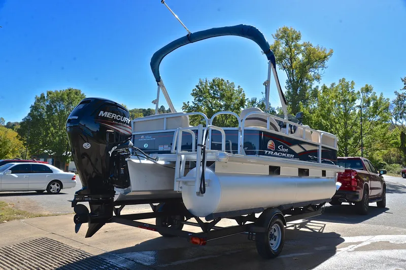 Slide: The Image of 2019 Sun Tracker Party Barge 18 DLX on trailer, parked outdoors. - 14
