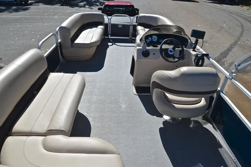 Slide: The Image of 2019 Sun Tracker Party Barge 18 DLX interior with spacious seating and steering console. - 18