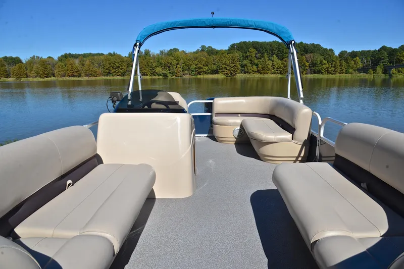 Slide: The Image of 2019 Sun Tracker Party Barge 18 DLX pontoon boat on a serene lake. - 20