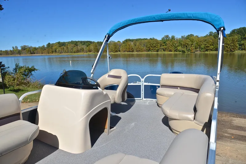Slide: The Image of 2019 Sun Tracker Party Barge 18 DLX pontoon boat on a serene lake. - 22