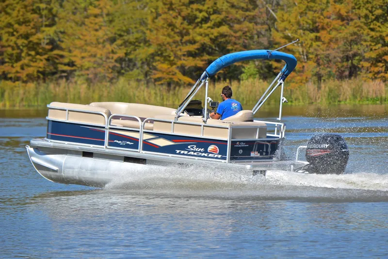 Slide: The Image of 2019 Sun Tracker Party Barge 18 DLX pontoon boat cruising on a lake. - 5
