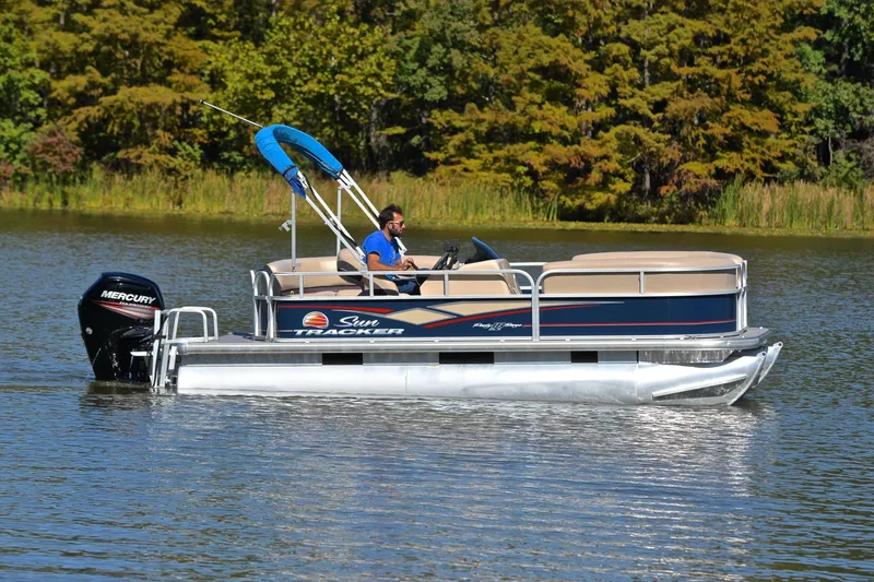 Slide: The Image of 2019 Sun Tracker Party Barge 18 DLX pontoon boat on a serene lake. - 7