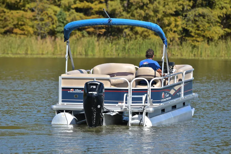 Slide: The Image of 2019 Sun Tracker Party Barge 18 DLX pontoon boat cruising on a serene lake. - 8