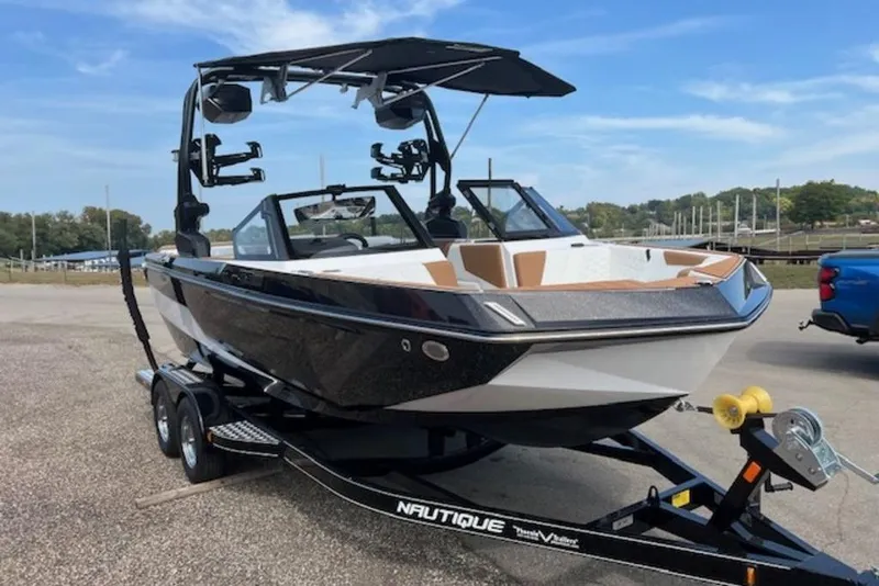 Slide: The Image of 2026 Nautique Super Air Nautique GS22 boat on trailer, parked outdoors. - 3