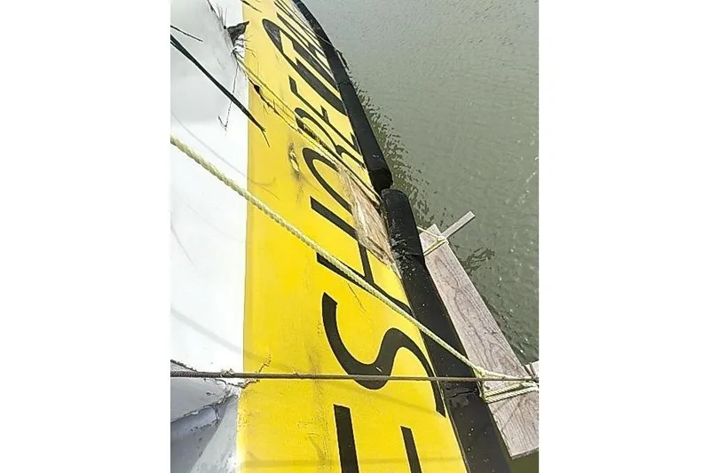 Slide: The Image of Yellow and black Mützelfeldtwerft Offshore Fast Crew Taxi Catamaran, 2016, docked on water. - 11