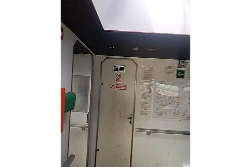 Slide: The Image of Interior of a 2016 Mützelfeldtwerft Offshore Fast Crew Taxi Catamaran, featuring a door and safety signs. - 24