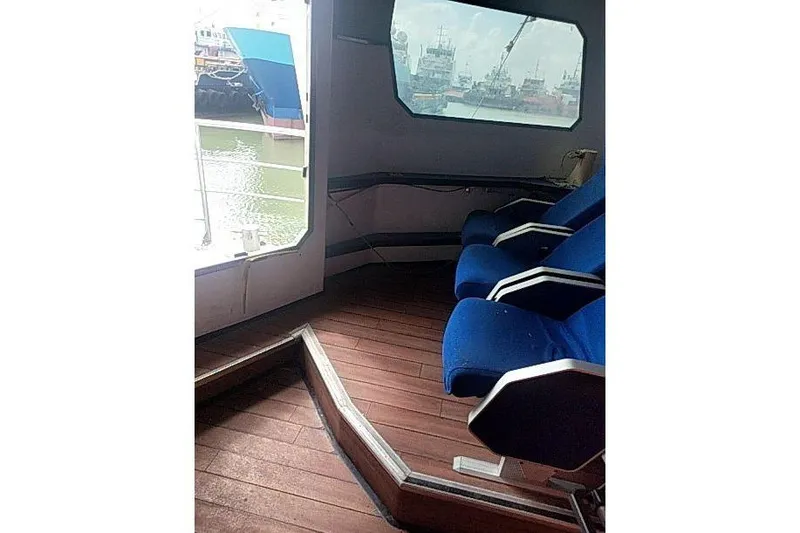 Slide: The Image of Interior of 2016 Mützelfeldtwerft Offshore Fast Crew Taxi Catamaran with blue seats and wooden floor. - 26