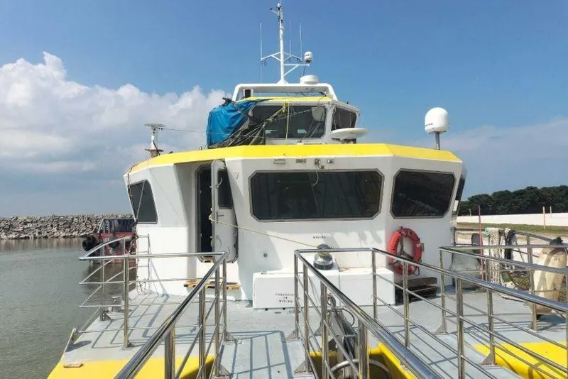 Slide: The Image of 2016 Mützelfeldtwerft Offshore Fast Crew Taxi Catamaran docked at a marina. - 4