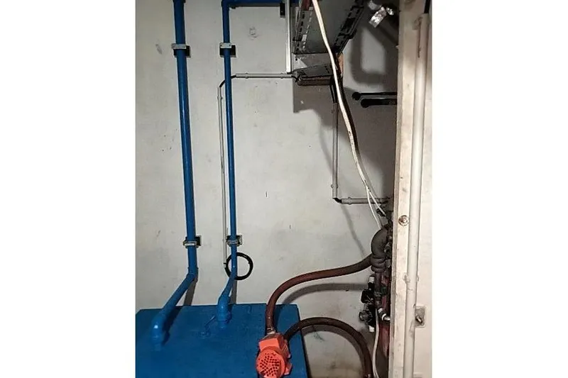 Slide: The Image of Engine room of 2016 Mützelfeldtwerft Offshore Fast Crew Taxi Catamaran with blue pipes and machinery. - 52