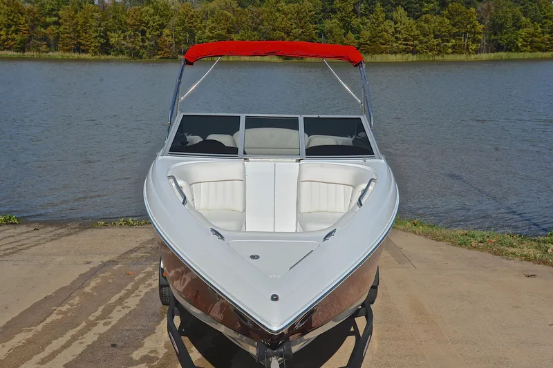 Slide: The Image of 2007 Cobalt 232 boat with red canopy on a lakefront ramp. - 14