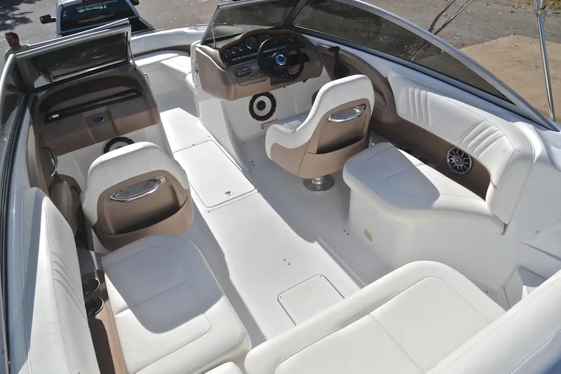 Slide: The Image of 2007 Cobalt 232 boat interior with white seating and modern dashboard. - 21