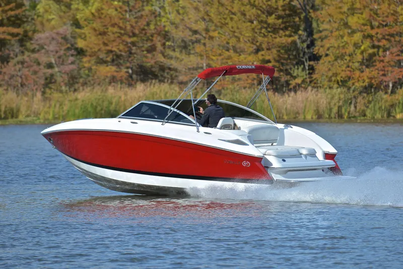 Slide: The Image of 2007 Cobalt 232 boat cruising on a lake with autumn trees in the background. - 4