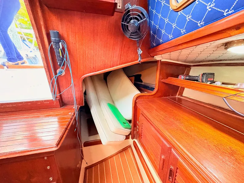 Slide: The Image of Interior of 1978 Islander 36 sailboat with wooden cabinetry and seating area. - 23