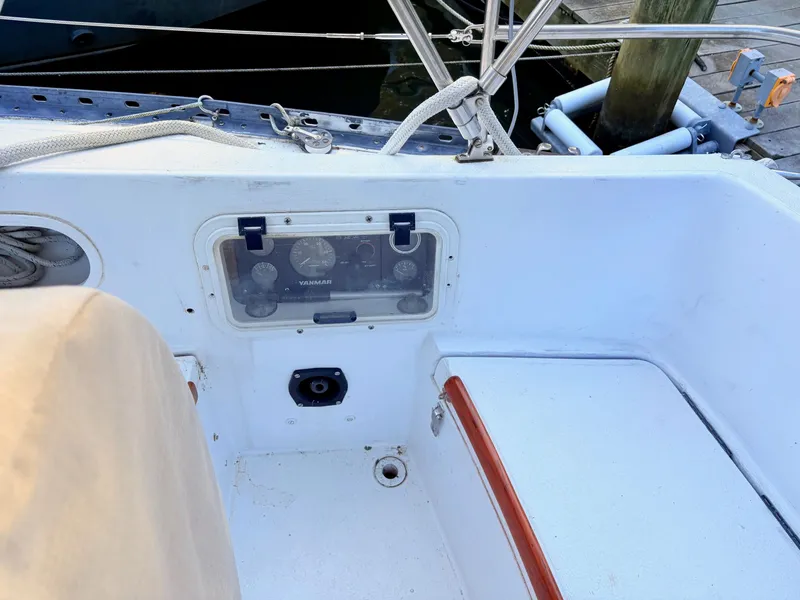 Slide: The Image of 1978 Islander 36 sailboat cockpit with Yanmar engine controls and seating area. - 28