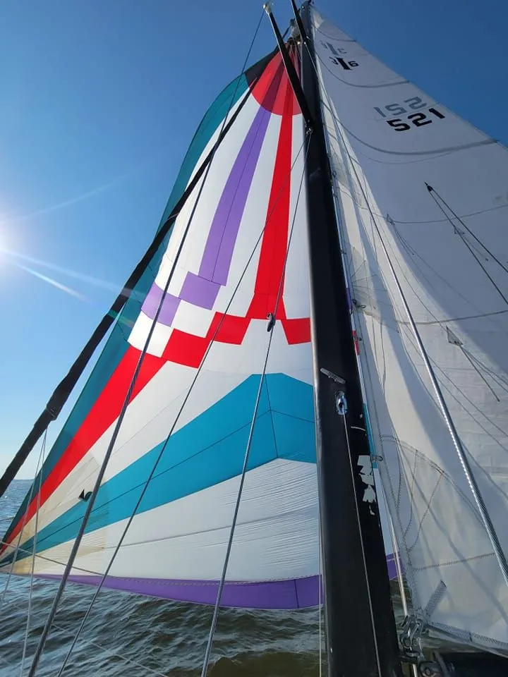 Slide: The Image of Colorful sails of a 1978 Islander 36 yacht against a clear blue sky. - 30