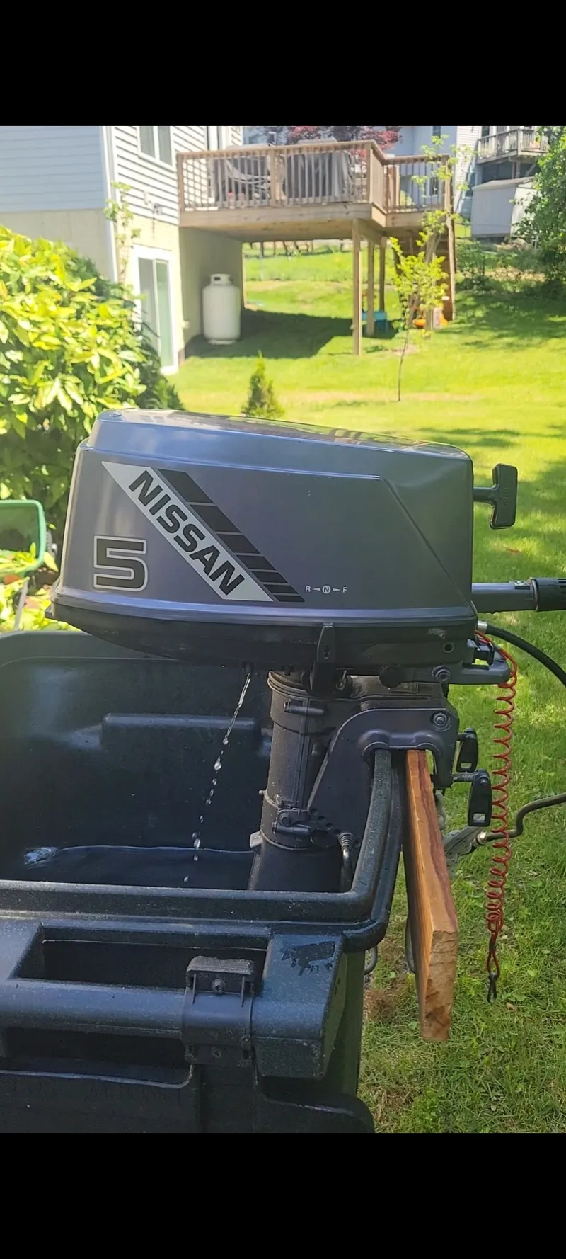Slide: The Image of Nissan 5 horsepower outboard motor in a garden setting, Islander 36, 1978. - 33