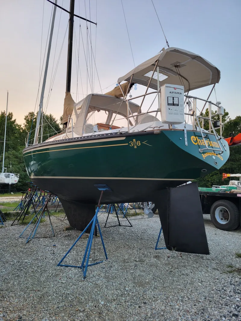 Slide: The Image of 1978 Islander 36 sailboat on stands, green hull, outdoor setting. - 7