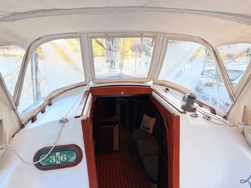 Slide: The Image of 1978 Islander 36 sailboat interior with wooden accents and clear canopy. - 9