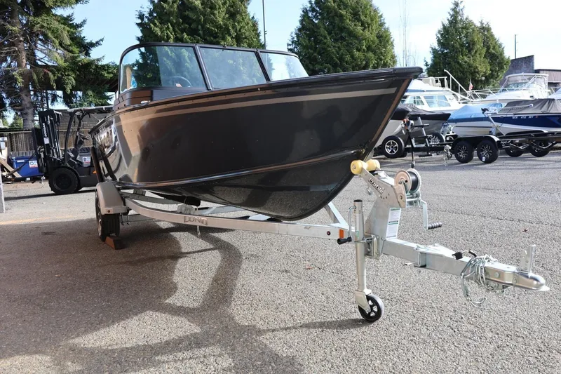 Slide: The Image of 2026 Lund 1675 Adventure Sport boat on trailer, parked outdoors. - 10
