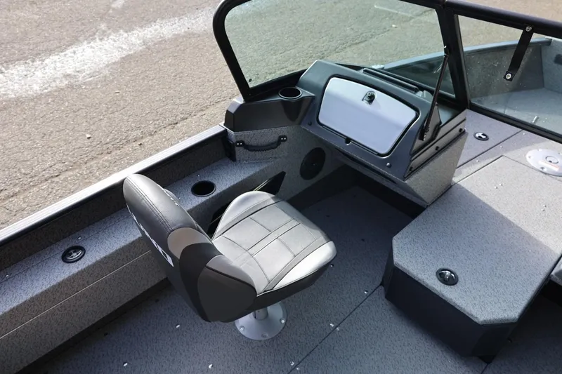Slide: The Image of 2026 Lund 1675 Adventure Sport boat interior with seating and dashboard. - 18