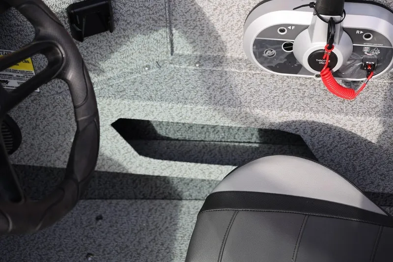 Slide: The Image of Interior of 2026 Lund 1675 Adventure Sport boat, featuring steering wheel and control panel. - 22