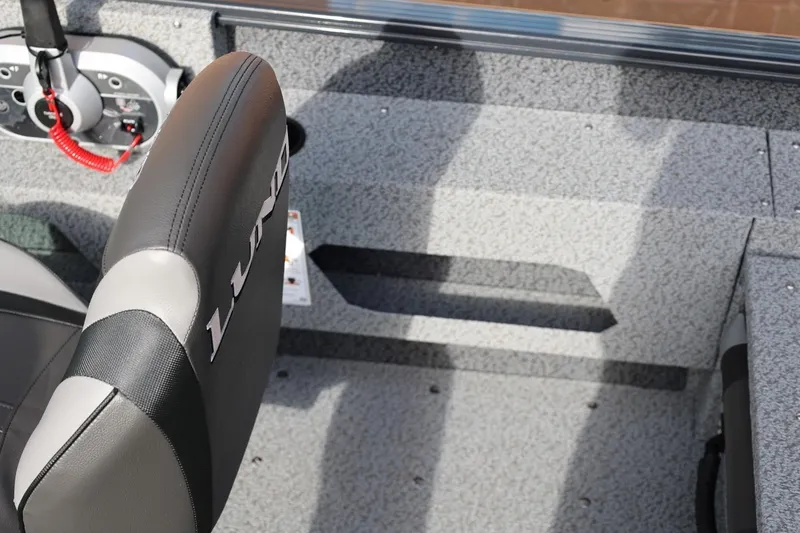Slide: The Image of Interior of 2026 Lund 1675 Adventure Sport boat, featuring seating and control panel. - 23