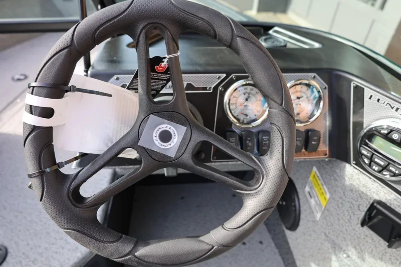 Slide: The Image of Steering wheel and dashboard of 2026 Lund 1675 Adventure Sport boat. - 24