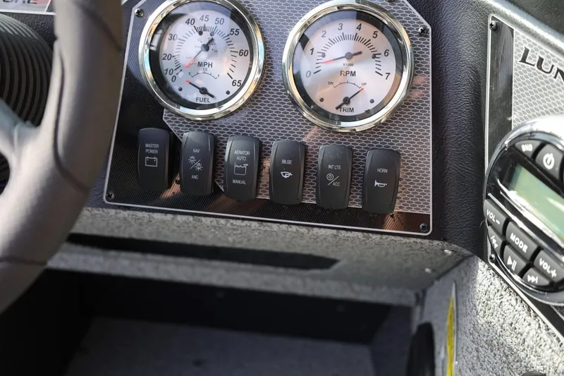Slide: The Image of Dashboard of 2026 Lund 1675 Adventure Sport boat with gauges and control switches. - 25