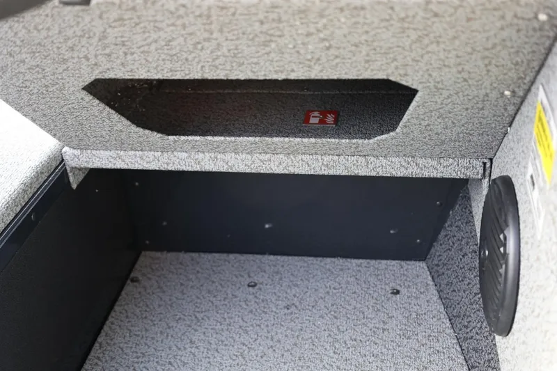 Slide: The Image of Storage compartment in 2026 Lund 1675 Adventure Sport boat, featuring textured interior and speaker. - 27