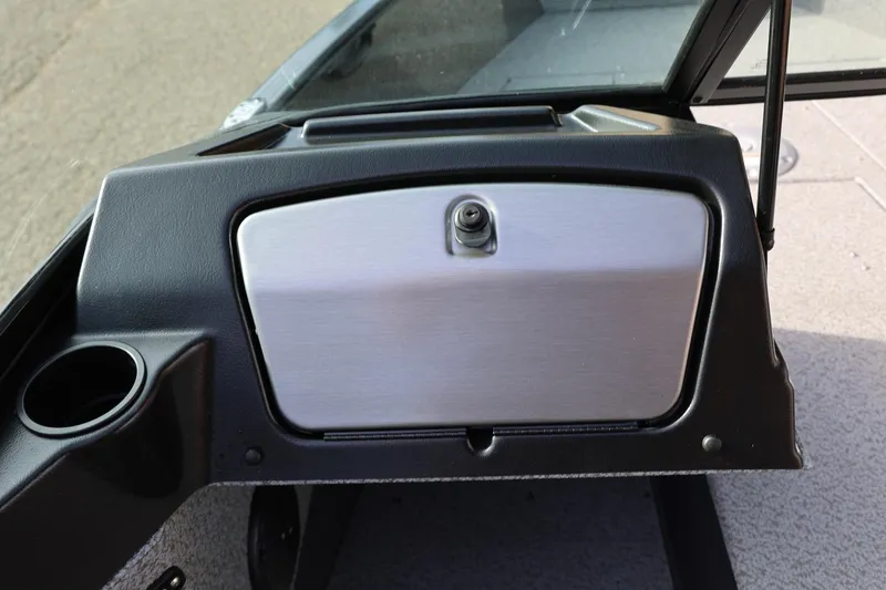 Slide: The Image of 2026 Lund 1675 Adventure Sport dashboard with glove compartment and cup holder. - 29