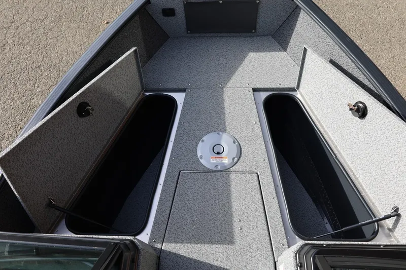 Slide: The Image of 2026 Lund 1675 Adventure Sport boat interior with open storage compartments. - 37