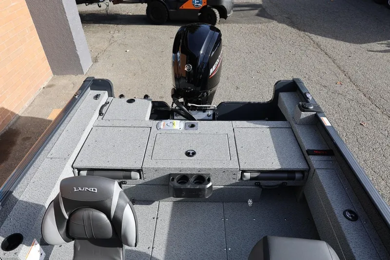 Slide: The Image of 2026 Lund 1675 Adventure Sport boat interior with Mercury engine, gray seating, and storage compartments. - 39