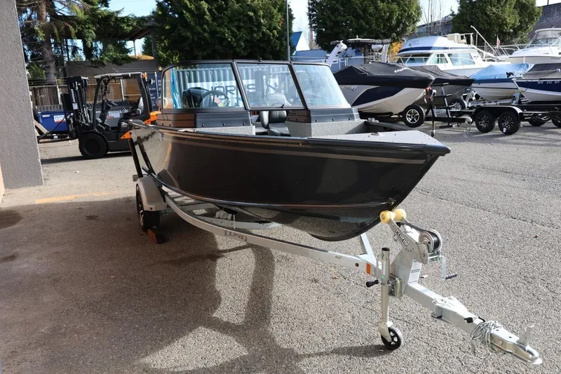 Slide: The Image of 2026 Lund 1675 Adventure Sport boat on trailer, parked outdoors. - 9