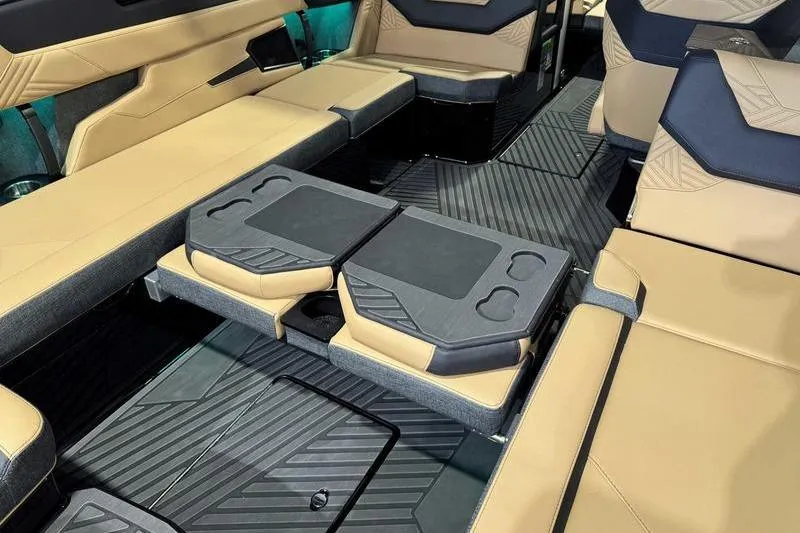 The Image of 2026 MasterCraft XStar 25 boat on trailer, parked near blue building. - 2