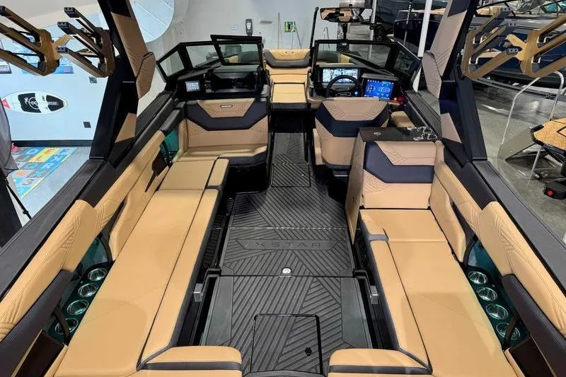 Slide: The Image of 2026 MasterCraft XStar 25 interior with luxurious seating and modern dashboard. - 28