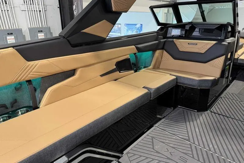 Slide: The Image of 2026 MasterCraft XStar 25 interior with tan and black seating, modern design, and sleek dashboard. - 31