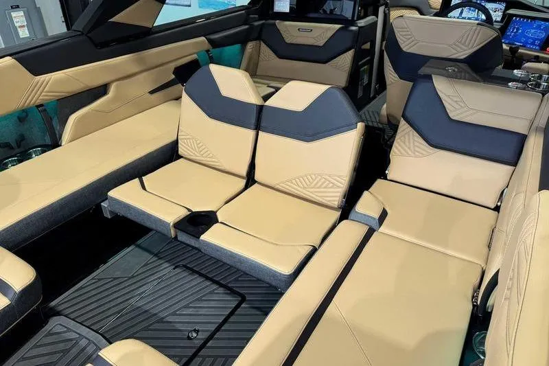 Slide: The Image of 2026 MasterCraft XStar 25 interior with luxurious tan and black seating. - 32