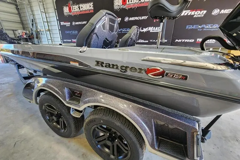 Slide: The Image of 2026 Ranger Z519R Cup-Equipped boat in showroom, featuring sleek design and dual axle trailer. - 12