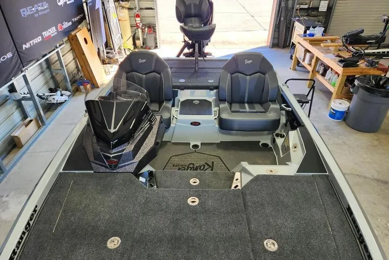 Slide: The Image of 2026 Ranger Z519R Cup-Equipped boat interior with seating and control panel in a garage. - 6