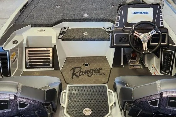 Slide: The Image of 2026 Ranger Z519R Cup-Equipped boat interior with steering wheel and branded flooring. - 8