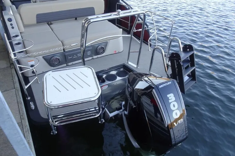 Slide: The Image of 2026 Harris Solstice 250 boat with Mercury 300 V8 engine, docked on water. - 10