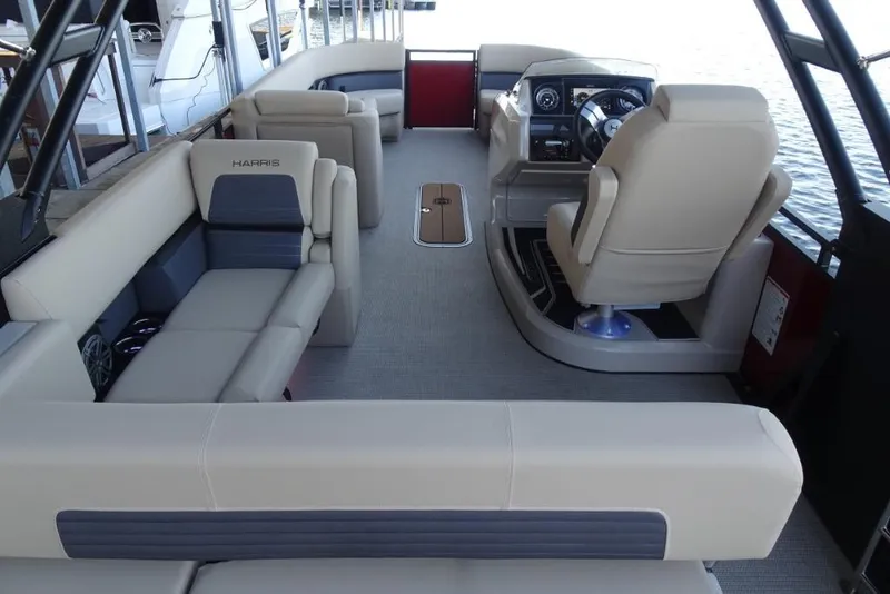 Slide: The Image of 2026 Harris Solstice 250 boat interior with luxurious seating and modern dashboard. - 13