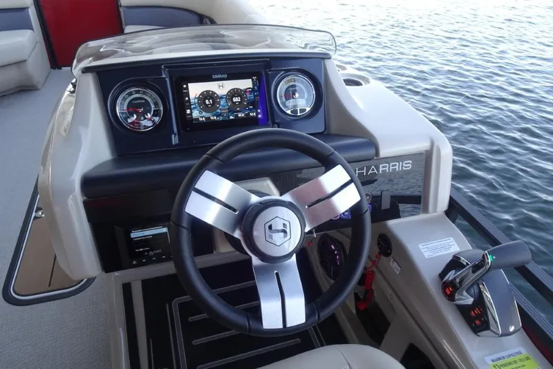 Slide: The Image of 2026 Harris Solstice 250 boat dashboard with steering wheel and digital display. - 16